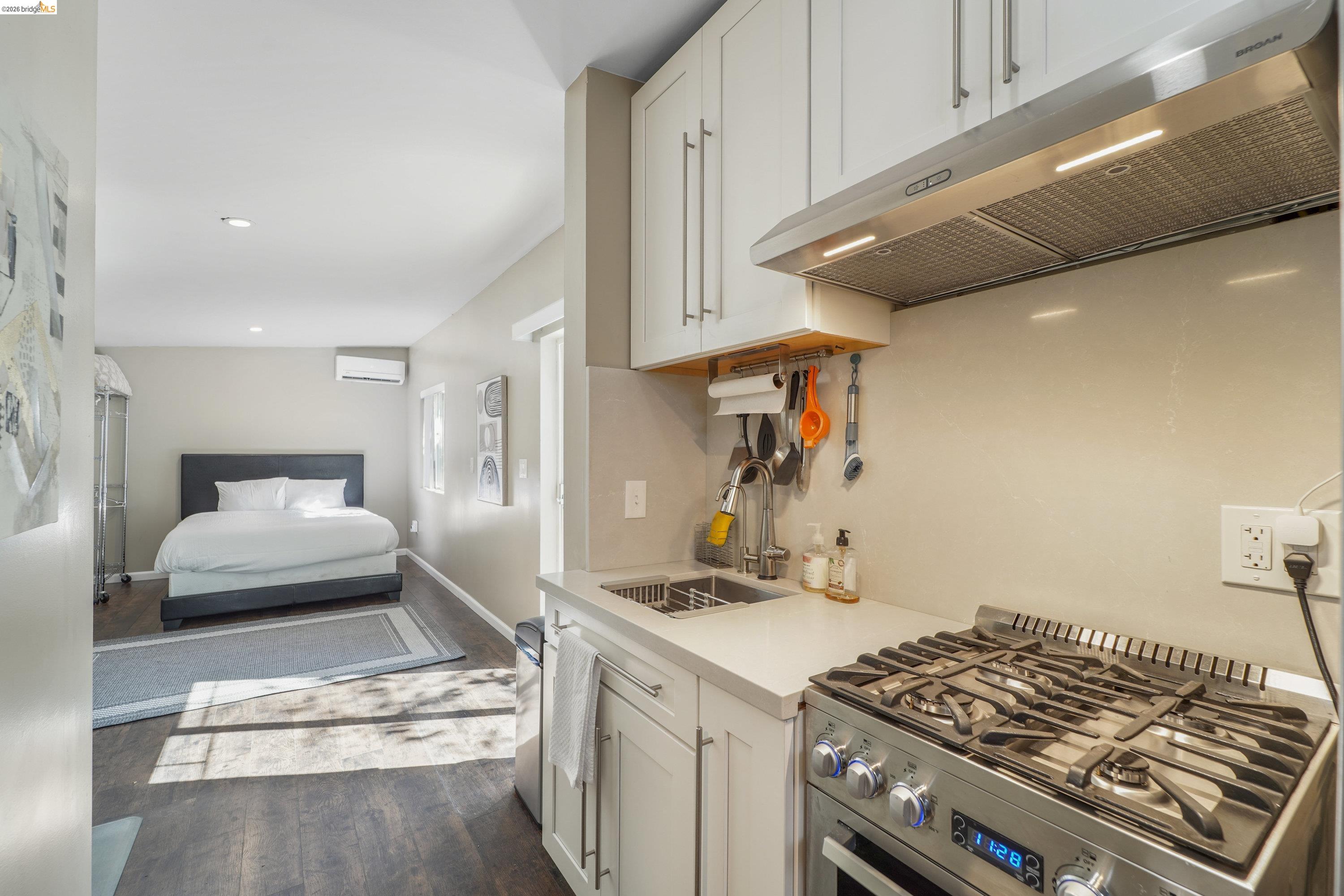 1662 14th Street Oakland, CA 94607 - Photo 35 of 57 a kitchen with stainless steel appliances granite countertop a stove and a sink