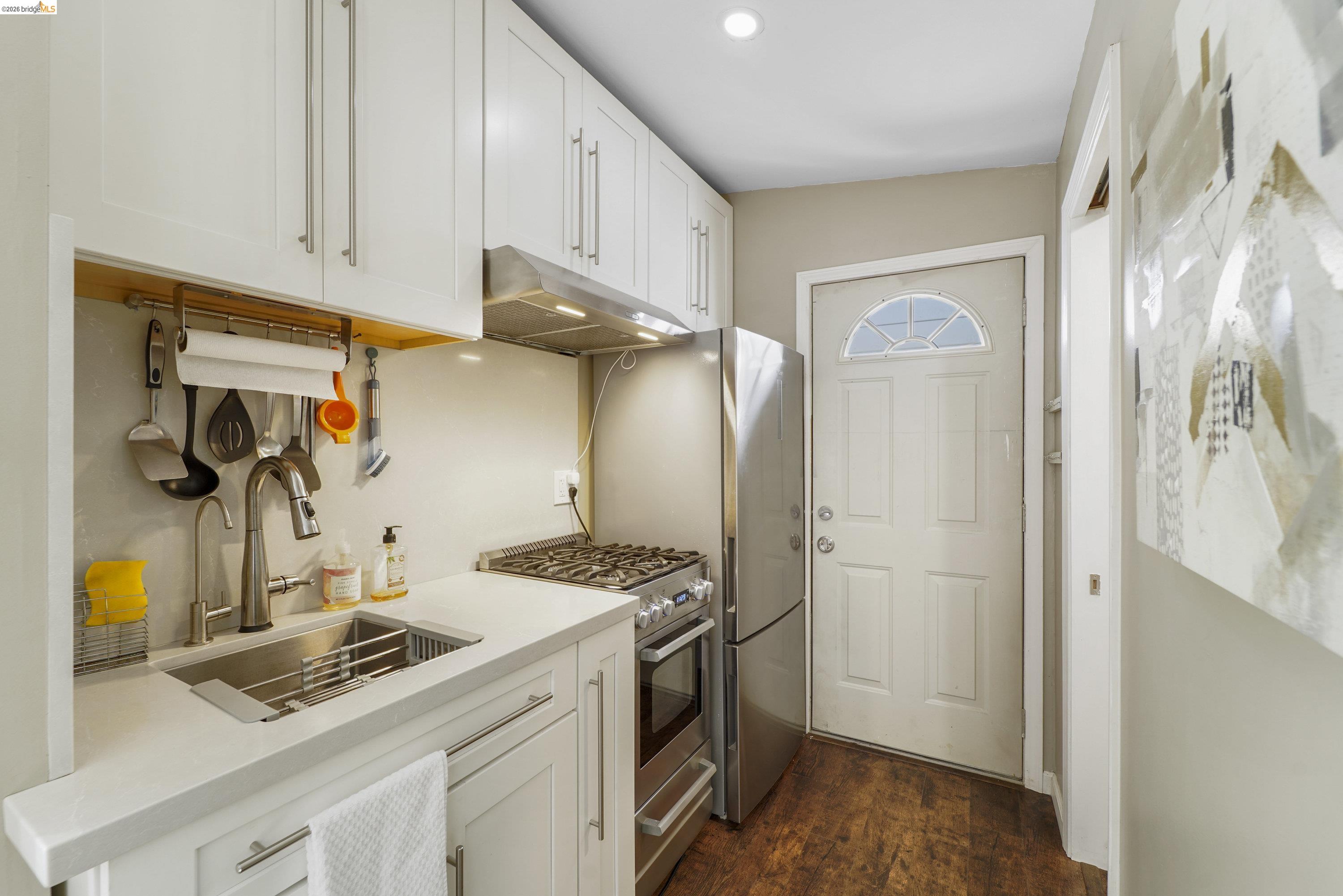 1662 14th Street Oakland, CA 94607 - Photo 36 of 57 a kitchen with stainless steel appliances granite countertop a sink stove and refrigerator