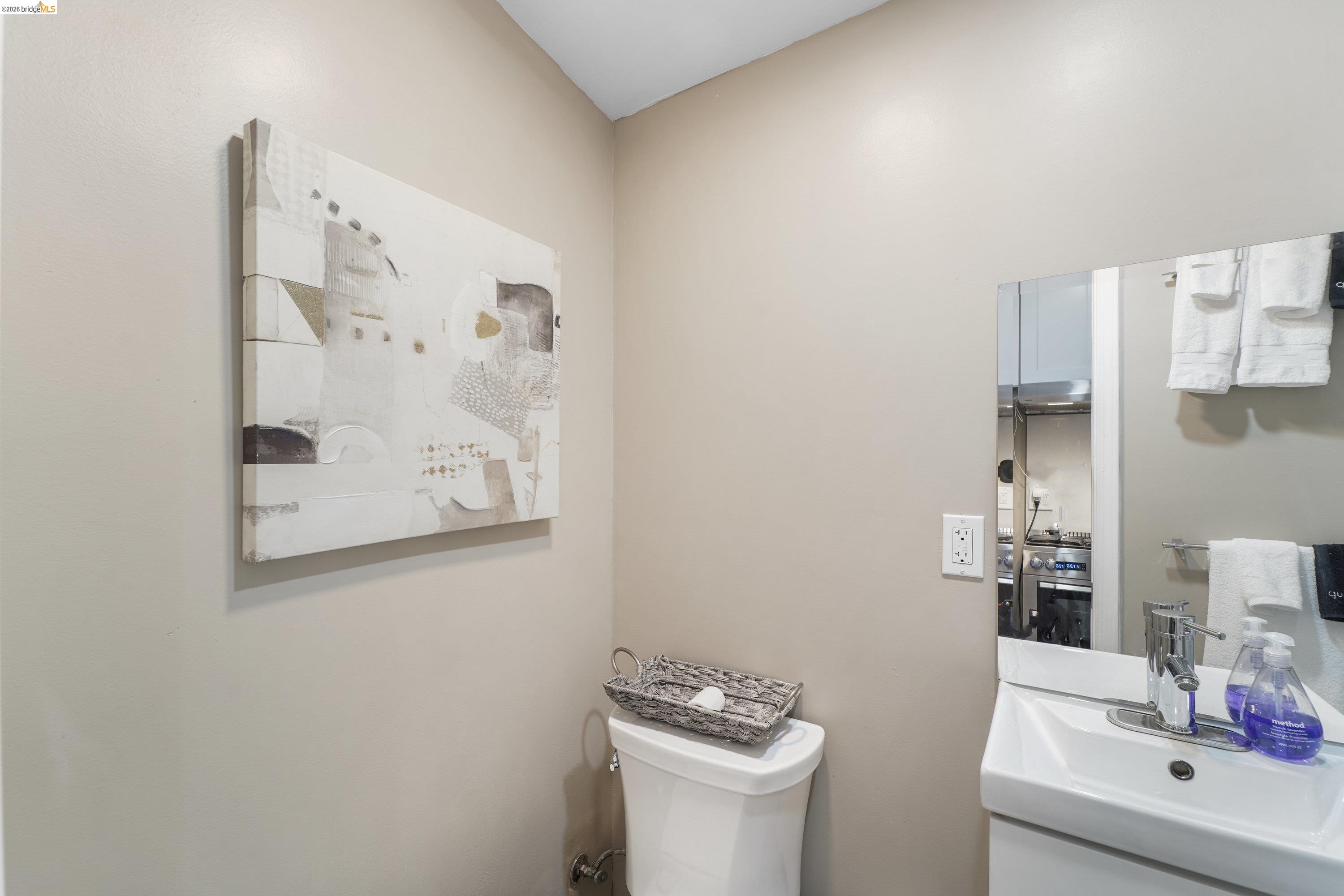 1662 14th Street Oakland, CA 94607 - Photo 38 of 57 a bathroom with a sink toilet and mirror