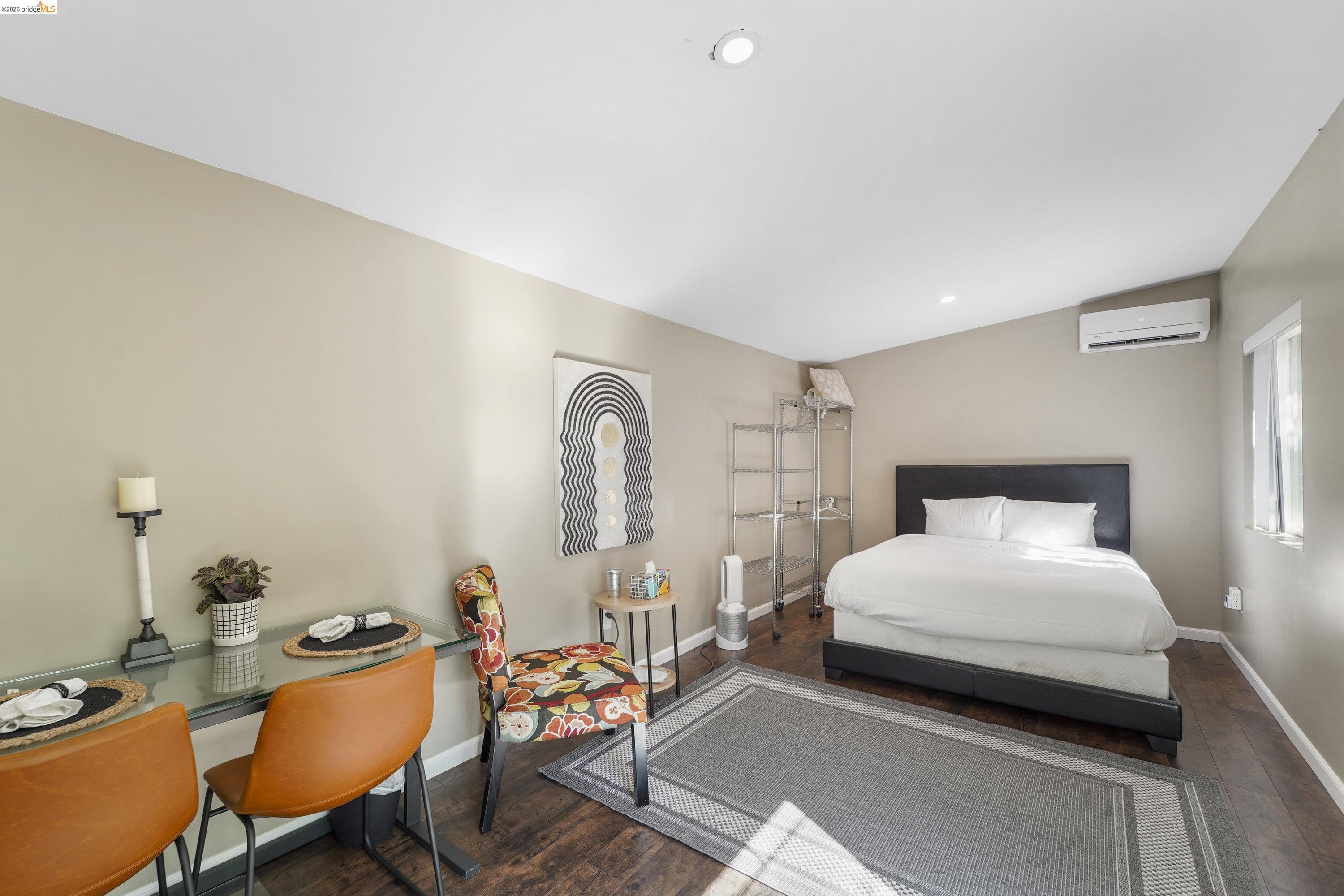 1662 14th Street Oakland, CA 94607 - Photo 39 of 57 a bedroom with a bed a table and chair