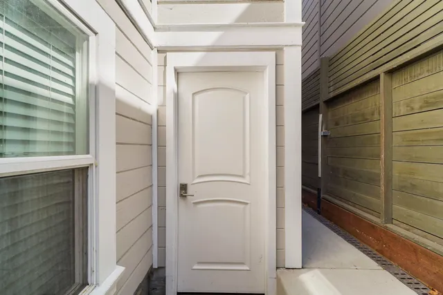 a view of a wooden house with a small yard and wooden floor and fence