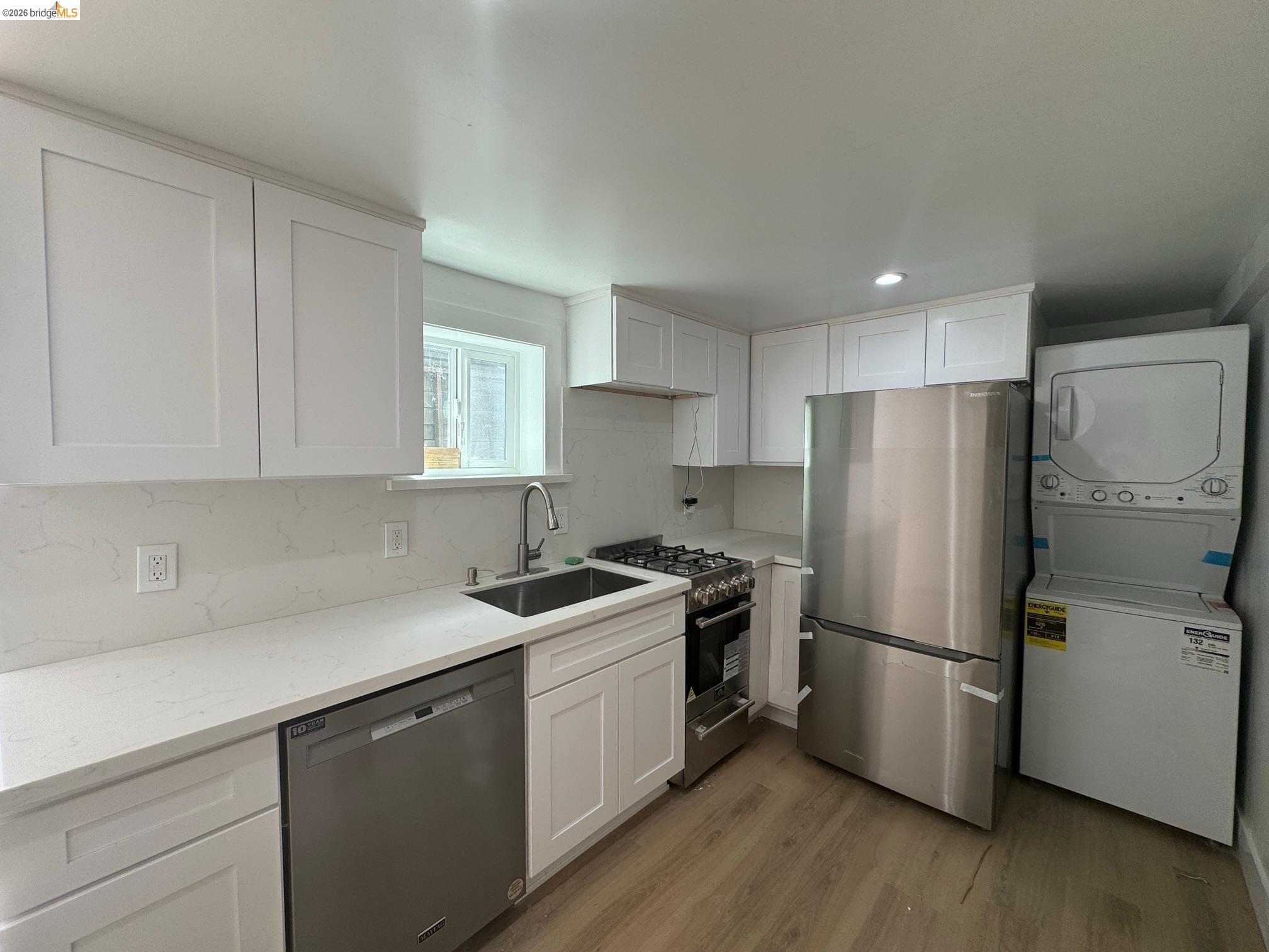 1662 14th Street Oakland, CA 94607 - Photo 49 of 57 a kitchen with a refrigerator sink and cabinets