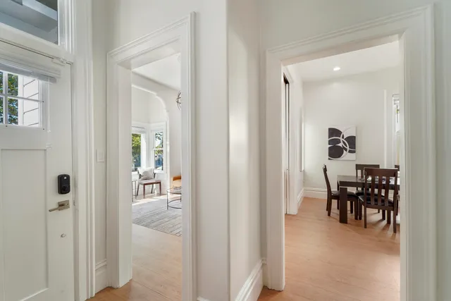 a living room with furniture a flat screen tv and a window