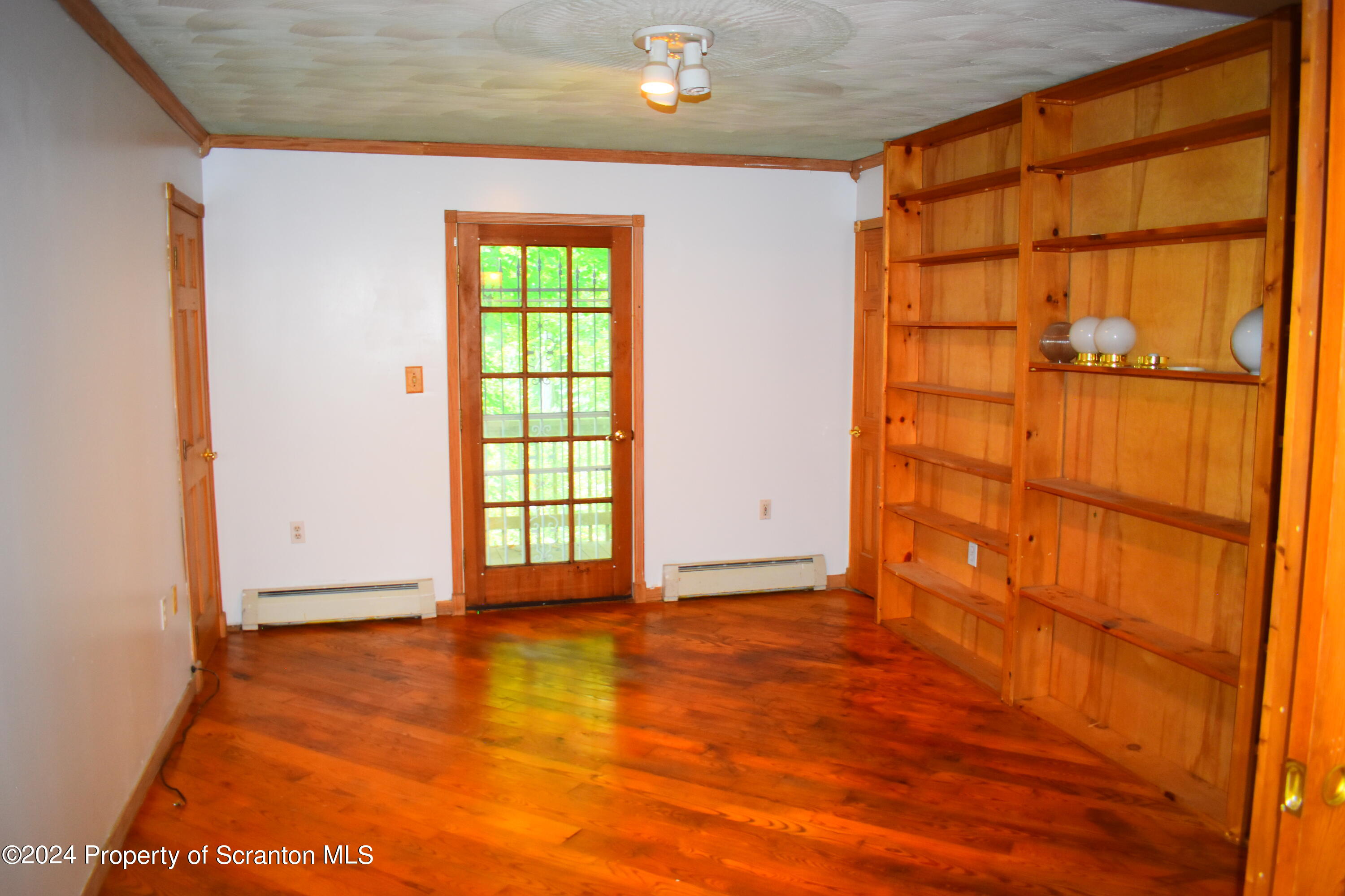 7678 State Rte 3023 Montrose, PA 18801 - Photo 11 of 29 an empty room with wooden floor and windows