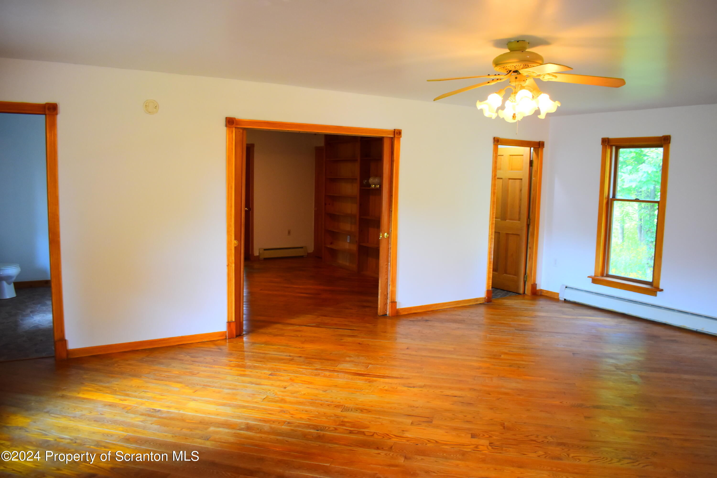 7678 State Rte 3023 Montrose, PA 18801 - Photo 8 of 29 a view of an empty room with window and wooden floor