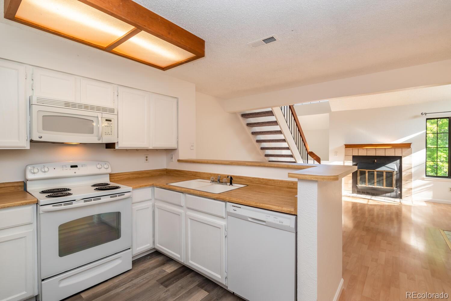 4795 White Rock Circle, Unit E Boulder, CO 80301 - Photo 8 of 26 a kitchen with stainless steel appliances granite countertop a stove a sink and a microwave