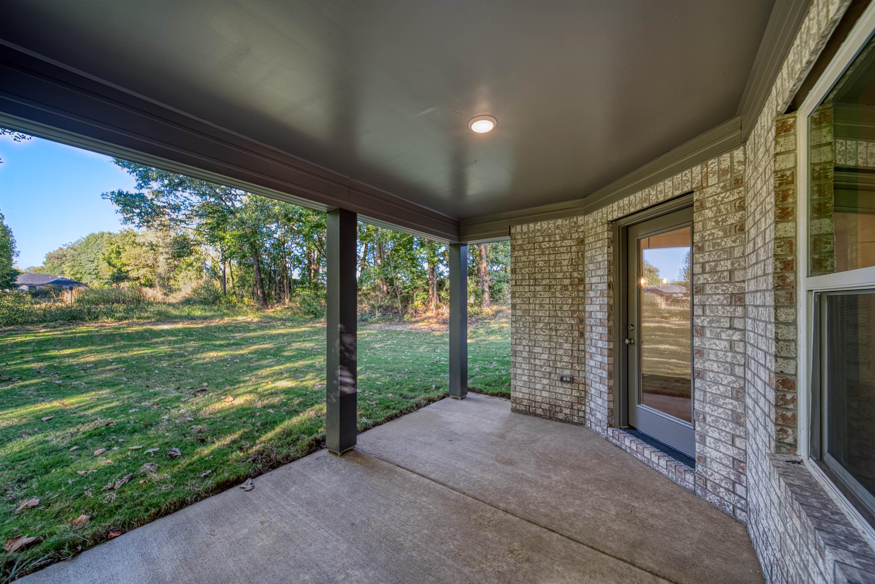 108 Walnut Ridge Ripley, TN 38063 - Photo 32 of 35 a view of a porch with a big yard and potted plants