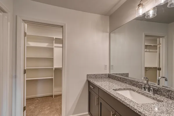 a kitchen with stainless steel appliances granite countertop a sink a stove a refrigerator a microwave and cabinets
