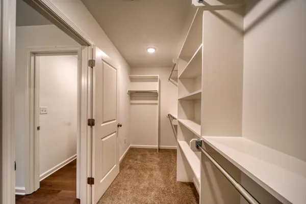a view of a hallway with white walls