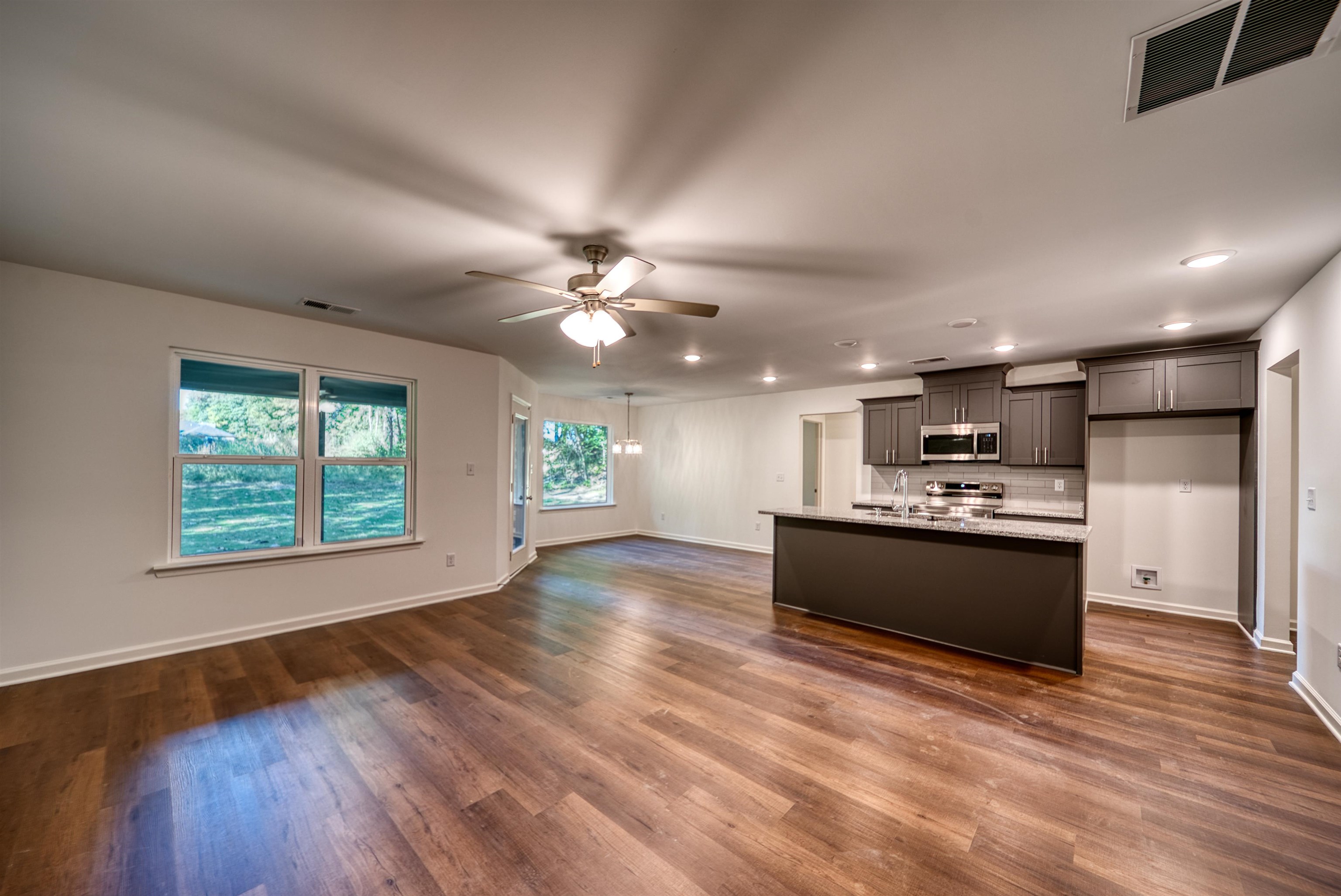 108 Walnut Ridge Ripley, TN 38063 - Photo 35 of 35 a view of a big room with wooden floor a kitchen view and a window