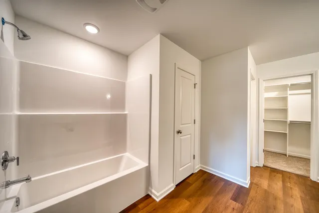 a bathroom with a bathtub and a shower