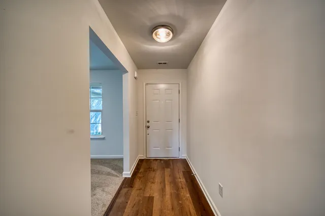 an empty room with windows and entrance