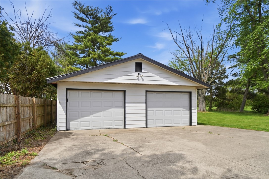 3991 Benner Road Miamisburg, OH 45342 - Photo 41 of 44 This detached two-car garage offers ample parking and storage, featuring durable vinyl siding and a wood fence.