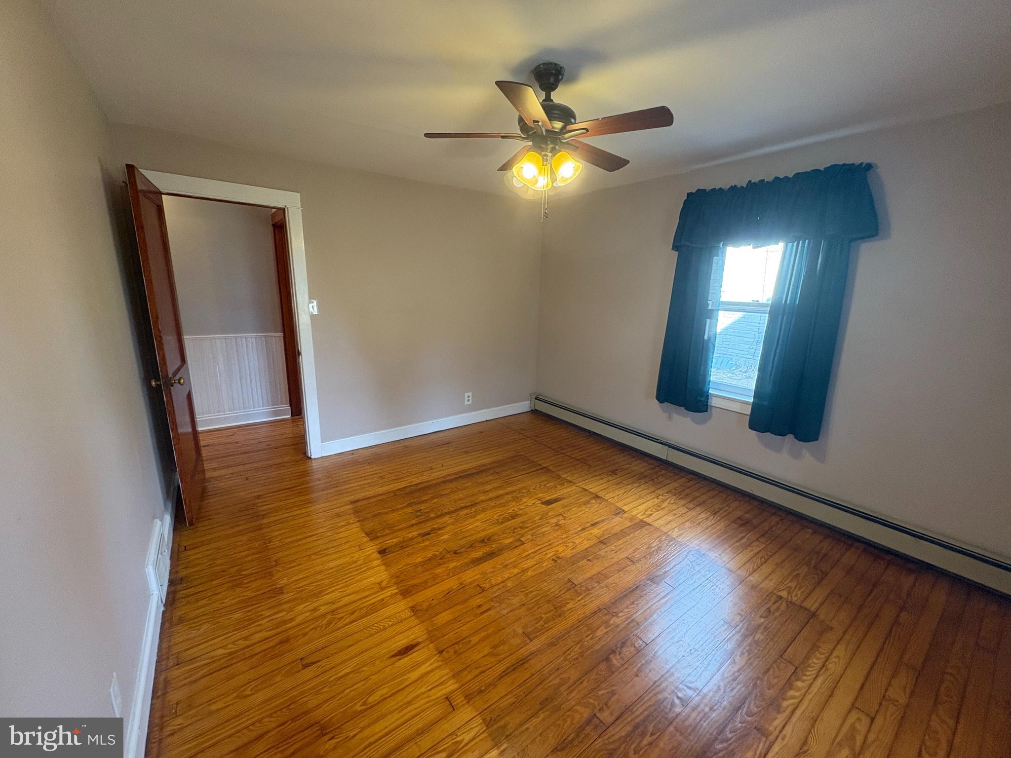 424 Lampeter Road Lancaster, PA 17602 - Photo 17 of 41 a view of an empty room with wooden floor and a window
