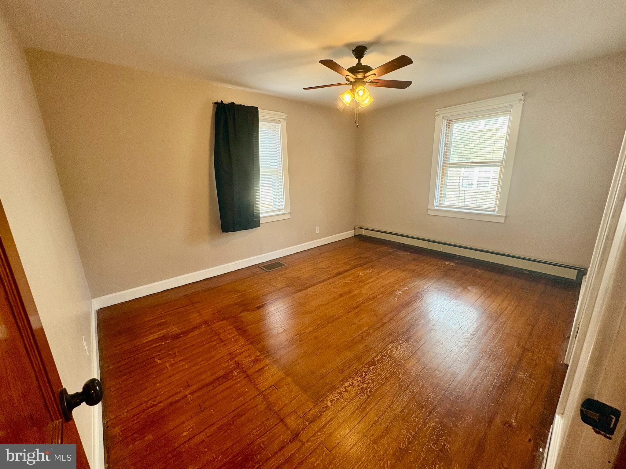 424 Lampeter Road Lancaster, PA 17602 - Photo 18 of 41 a view of an empty room with wooden floor and a window