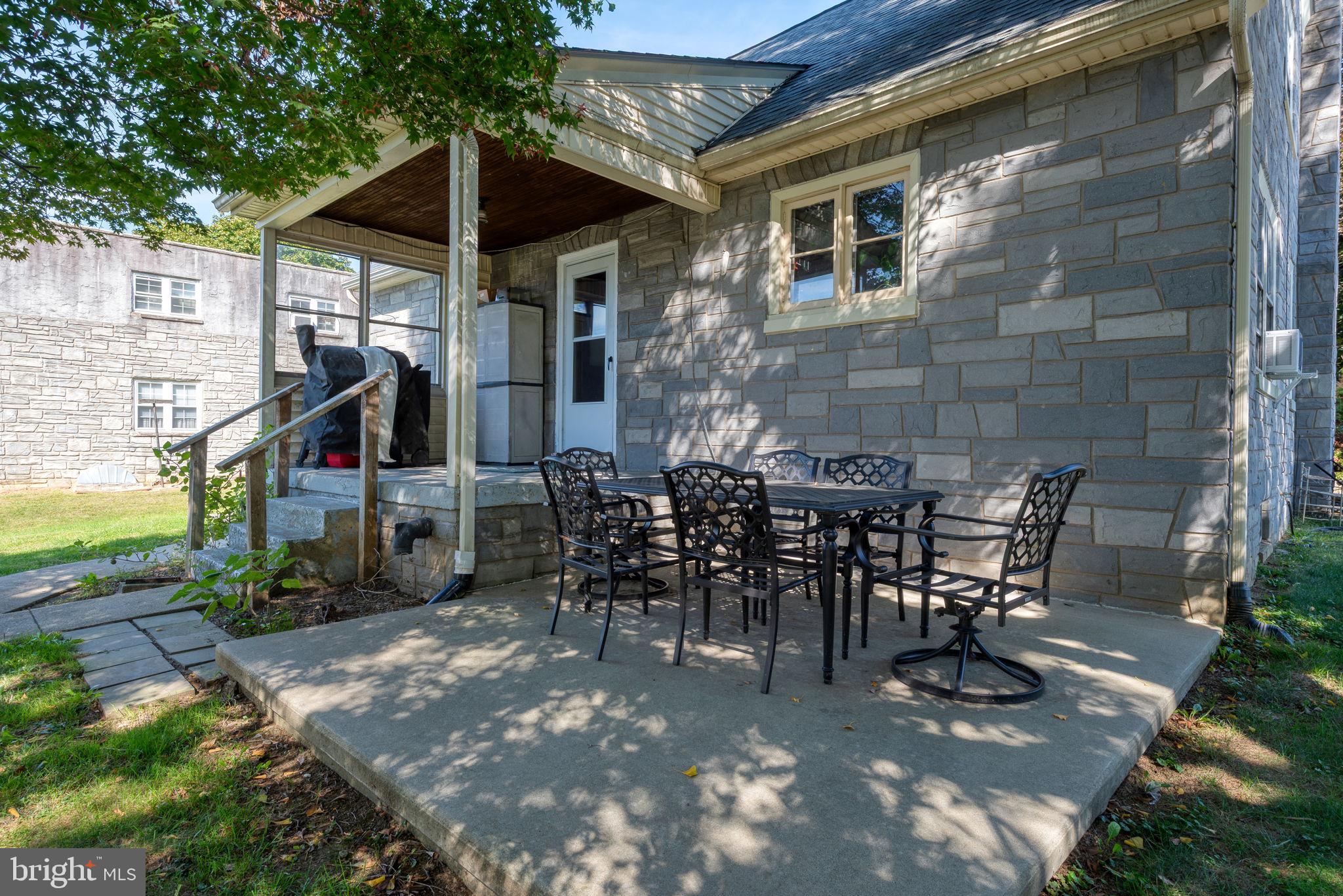 424 Lampeter Road Lancaster, PA 17602 - Photo 32 of 41 a view of a patio with table and chairs potted plants and floor to ceiling window