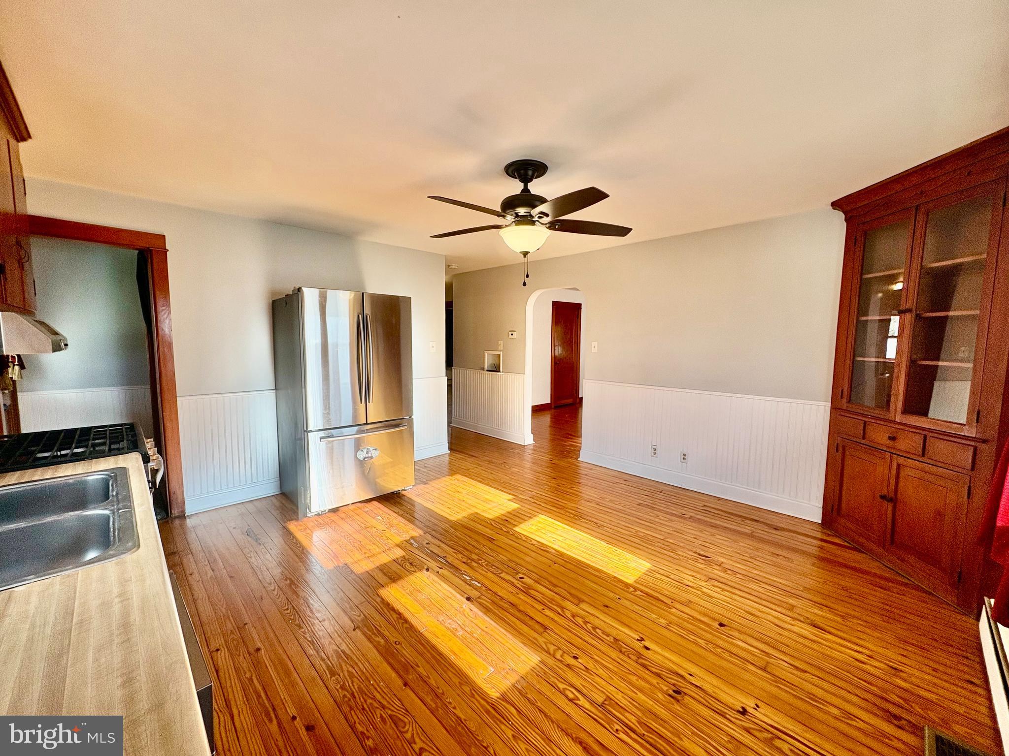 424 Lampeter Road Lancaster, PA 17602 - Photo 7 of 41 a view of a kitchen with kitchen island a sink wooden floor and a refrigerator