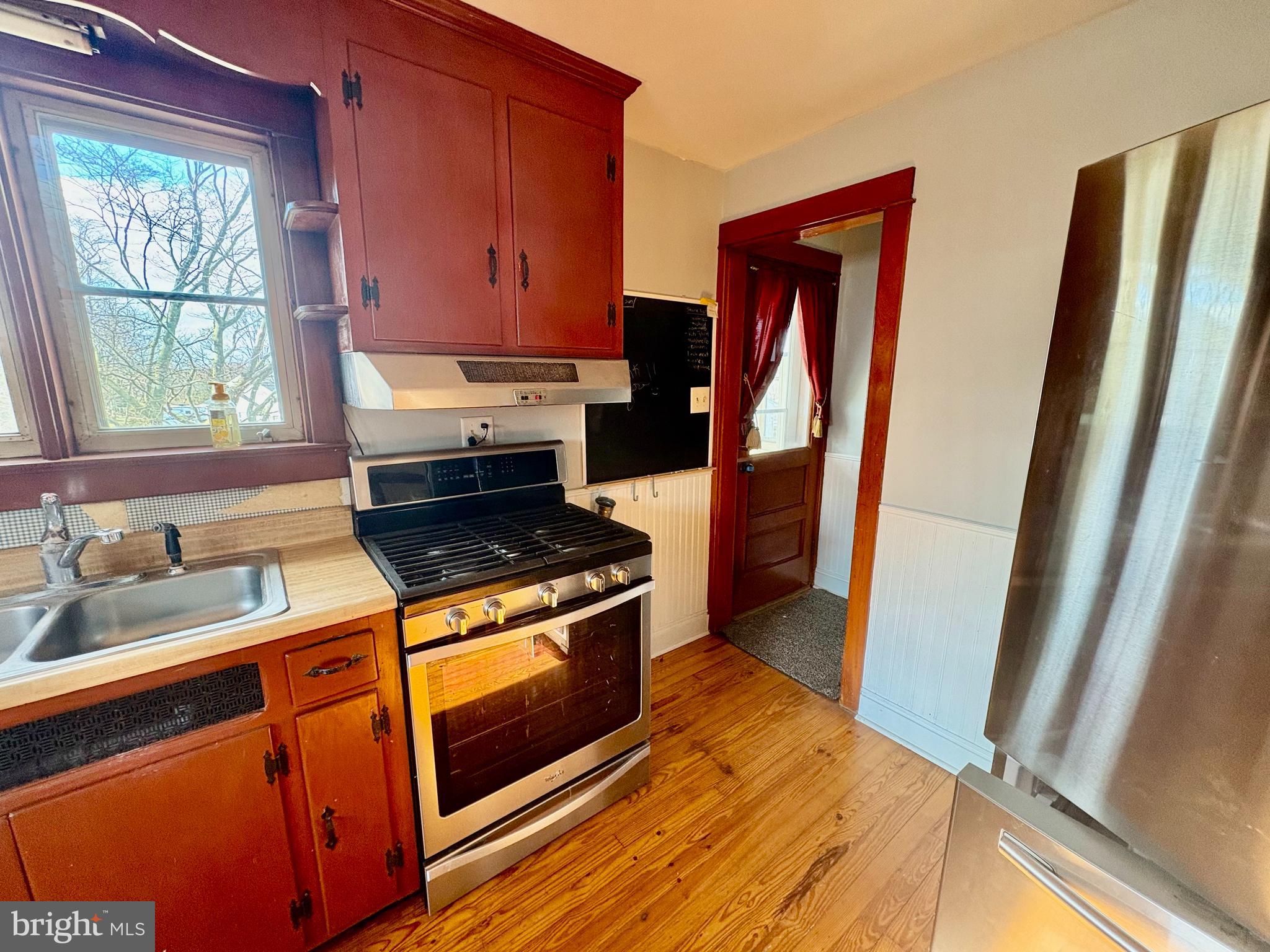 424 Lampeter Road Lancaster, PA 17602 - Photo 9 of 41 a kitchen with wooden floor and a stove top oven