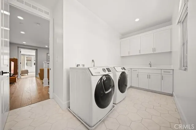 a spacious bedroom with a bed and a chandelier