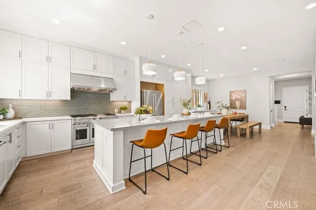 a large kitchen with lots of counter space and furniture