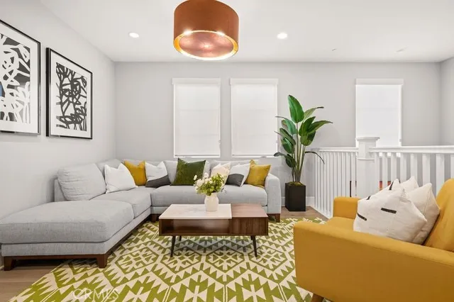a living room with furniture and a potted plant