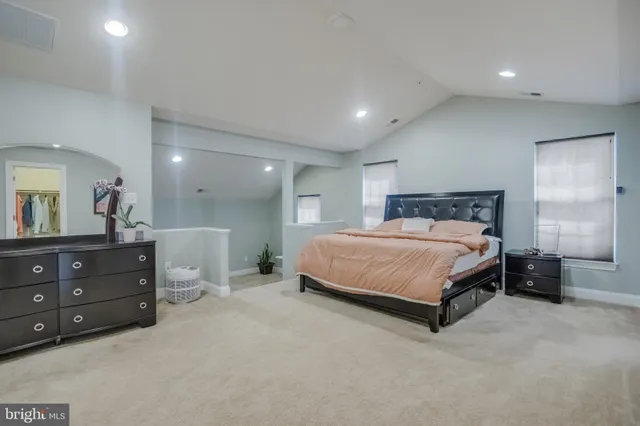 an empty room with furniture and a ceiling fan