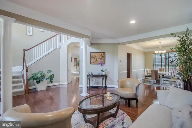 a view of a dining room with furniture wooden floor and chandelier