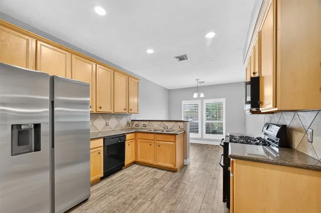 a kitchen with a sink stove and cabinets