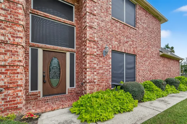 a front view of a house with garden