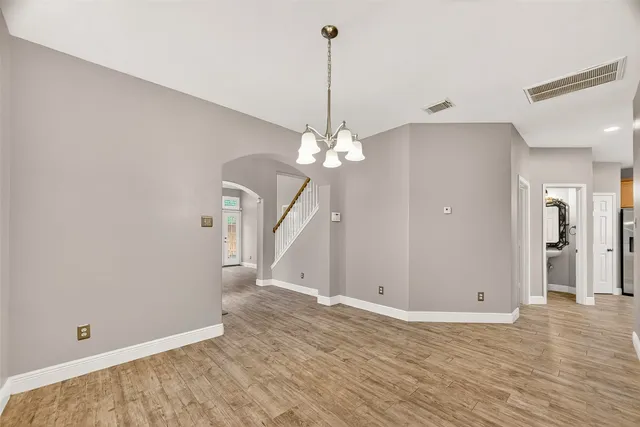 a view of a room with wooden floor and ceiling fan