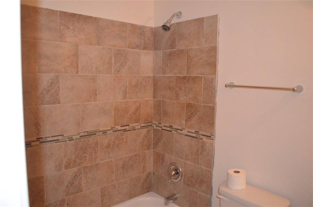 1329 Westridge Road Southwest Atlanta, GA 30311 - Photo 35 of 54 a bathroom with a shower and a toilet