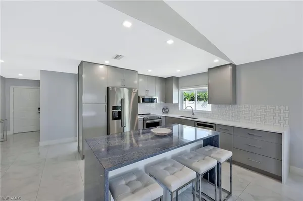 a kitchen with counter top space and living room