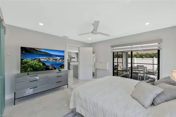 a bedroom with a large bed and a chandelier