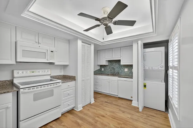 a kitchen with a stove cabinets and wooden floor