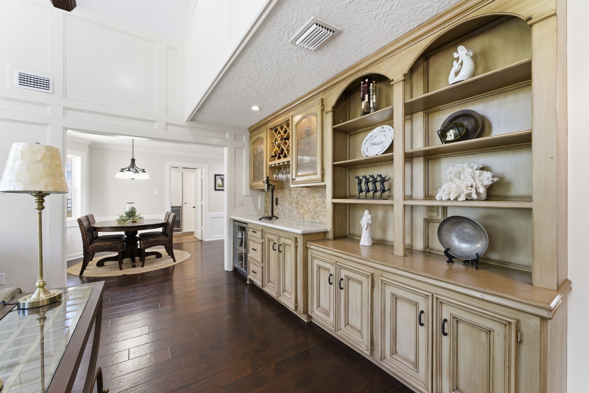 20 Falling Star Road The Woodlands, TX 77381 - Photo 13 of 44 The living room showcases elegant built-in shelves and cabinets. The hardwood floors and light walls create a warm, inviting atmosphere.