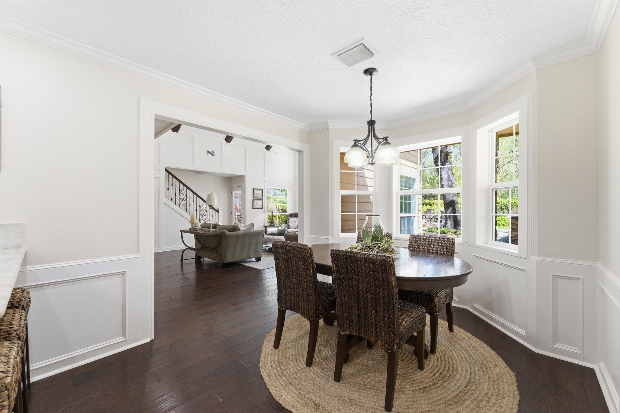 20 Falling Star Road The Woodlands, TX 77381 - Photo 14 of 44 Bright breakfast area with large windows, dark hardwood floors, and a stylish chandelier. The space opens to the living room