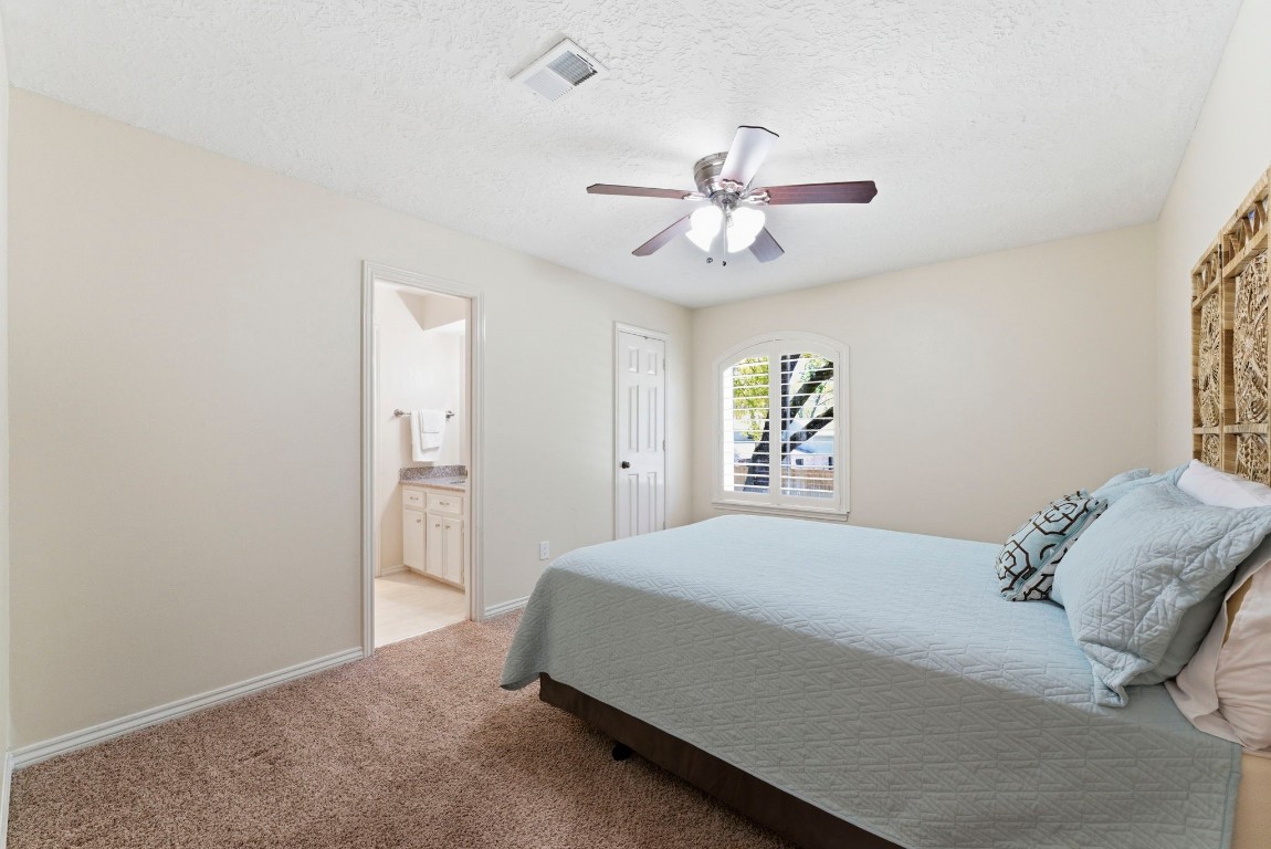 20 Falling Star Road The Woodlands, TX 77381 - Photo 30 of 44 Secondary bedroom #2 features neutral walls, a cozy carpet, and a modern ceiling fan. It includes a hollywood bathroom with a vanity, and a window with shutters offers natural light.
