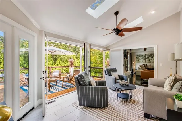 a living room with furniture and a floor to ceiling window