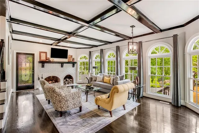 a living room with furniture fireplace and flat screen tv