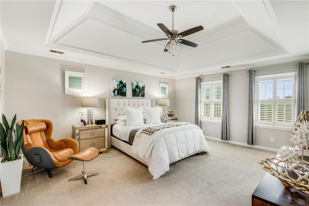 2995 Coles Way Atlanta, GA 30350 - Photo 18 of 44 a spacious bedroom with a bed a couch and a window