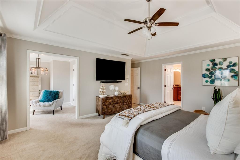 2995 Coles Way Atlanta, GA 30350 - Photo 19 of 44 a bedroom with a bed a flat screen tv and a couch