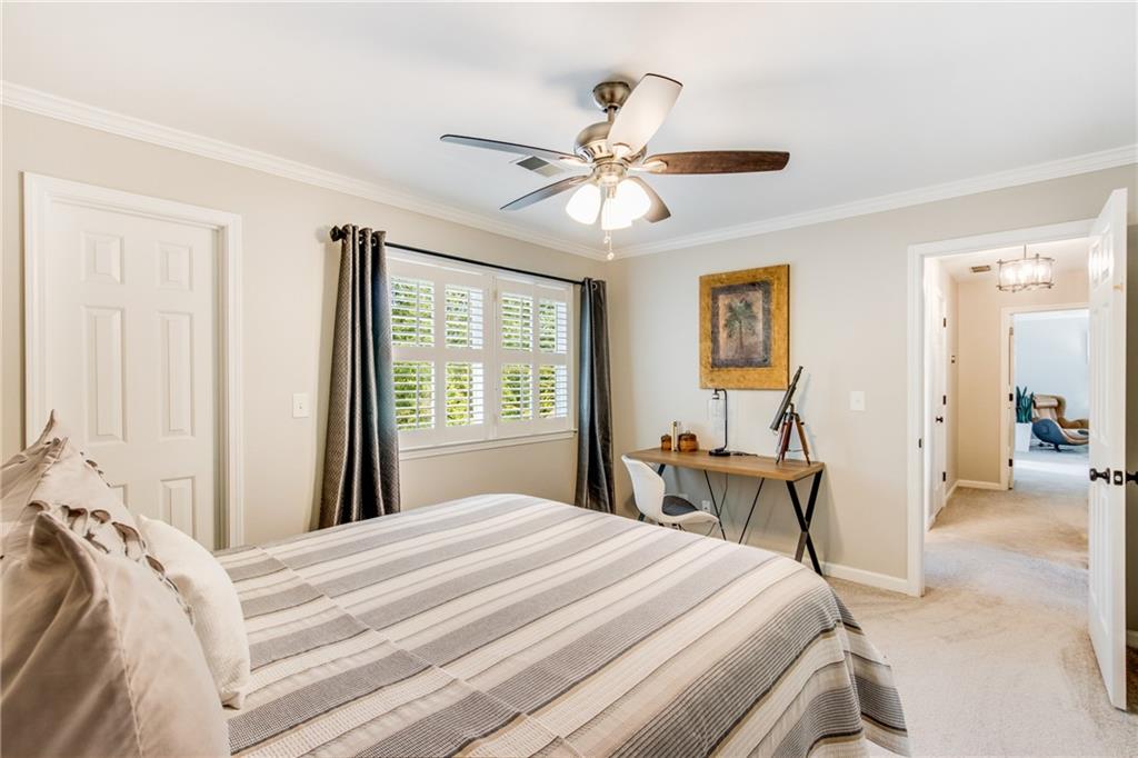 2995 Coles Way Atlanta, GA 30350 - Photo 24 of 44 a bedroom with a bed and a chandelier