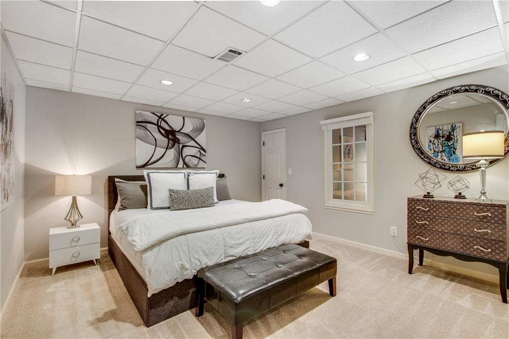 2995 Coles Way Atlanta, GA 30350 - Photo 32 of 44 a bedroom with a bed a mirror on dresser and a window