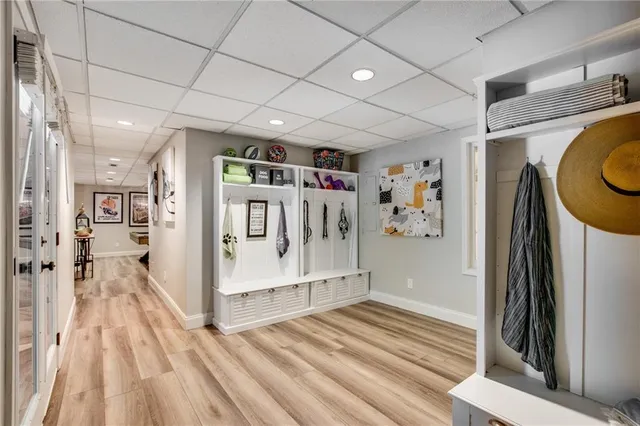 a view of a hallway with wooden floor and entryway
