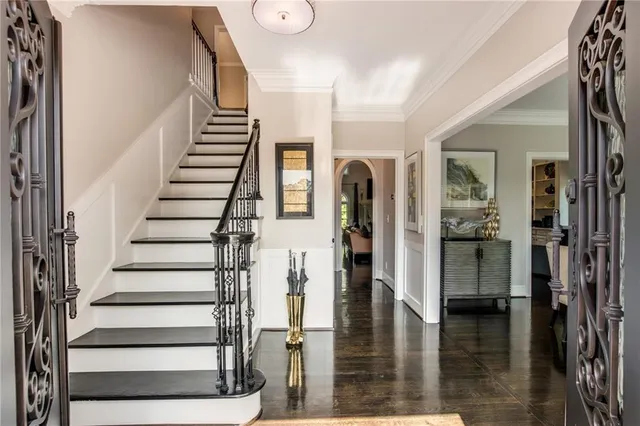 a view of entryway and hall with wooden floor