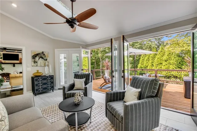 a living room with furniture and a floor to ceiling window