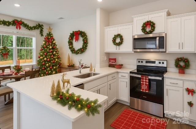 a kitchen with stainless steel appliances kitchen island granite countertop a sink and a microwave