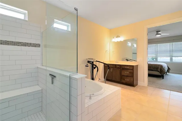 a en suite bathroom with a double vanity sink a mirror and shower