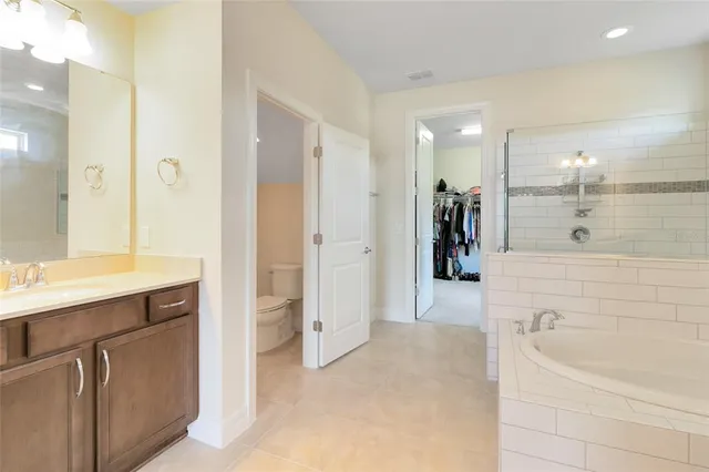 a bathroom with a bathtub shower sink and mirror