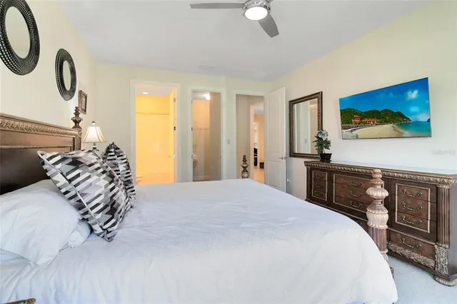 a bedroom with a bed and a flat tv screen on dresser